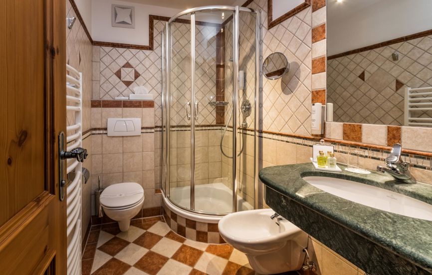 Bathroom with shower, sink, toilet, and bidet